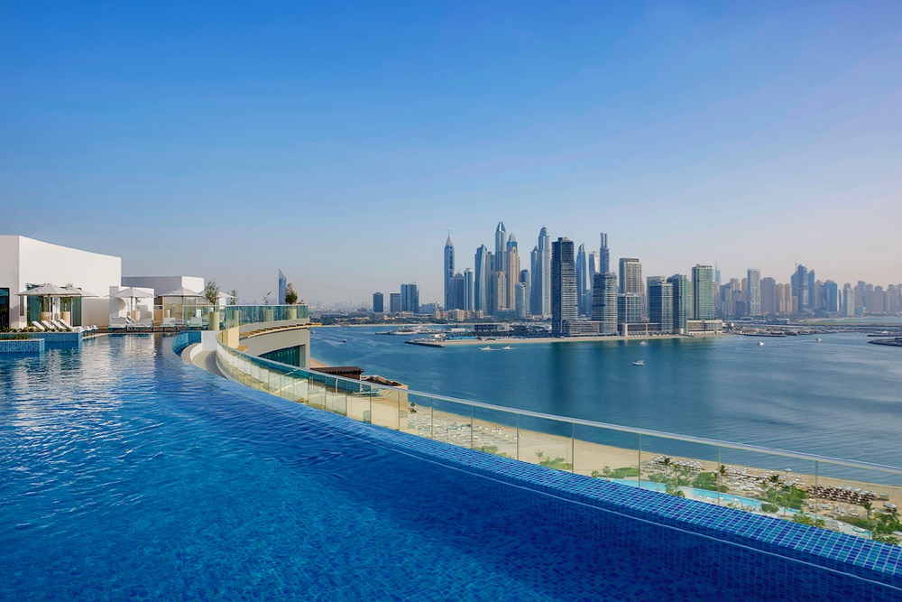 NH Collection Dubai The Palm pool with beach and skyline view