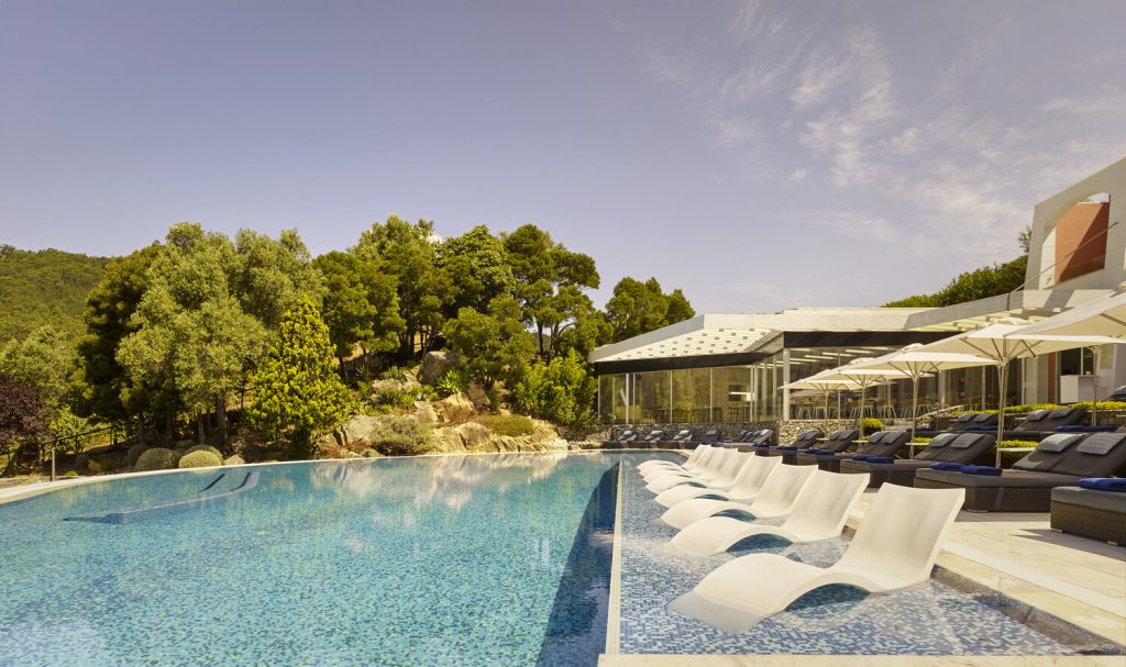 View of resort swimming pool at Ritz carlton Penha Longa in portugal with sunbeds in the shallow water