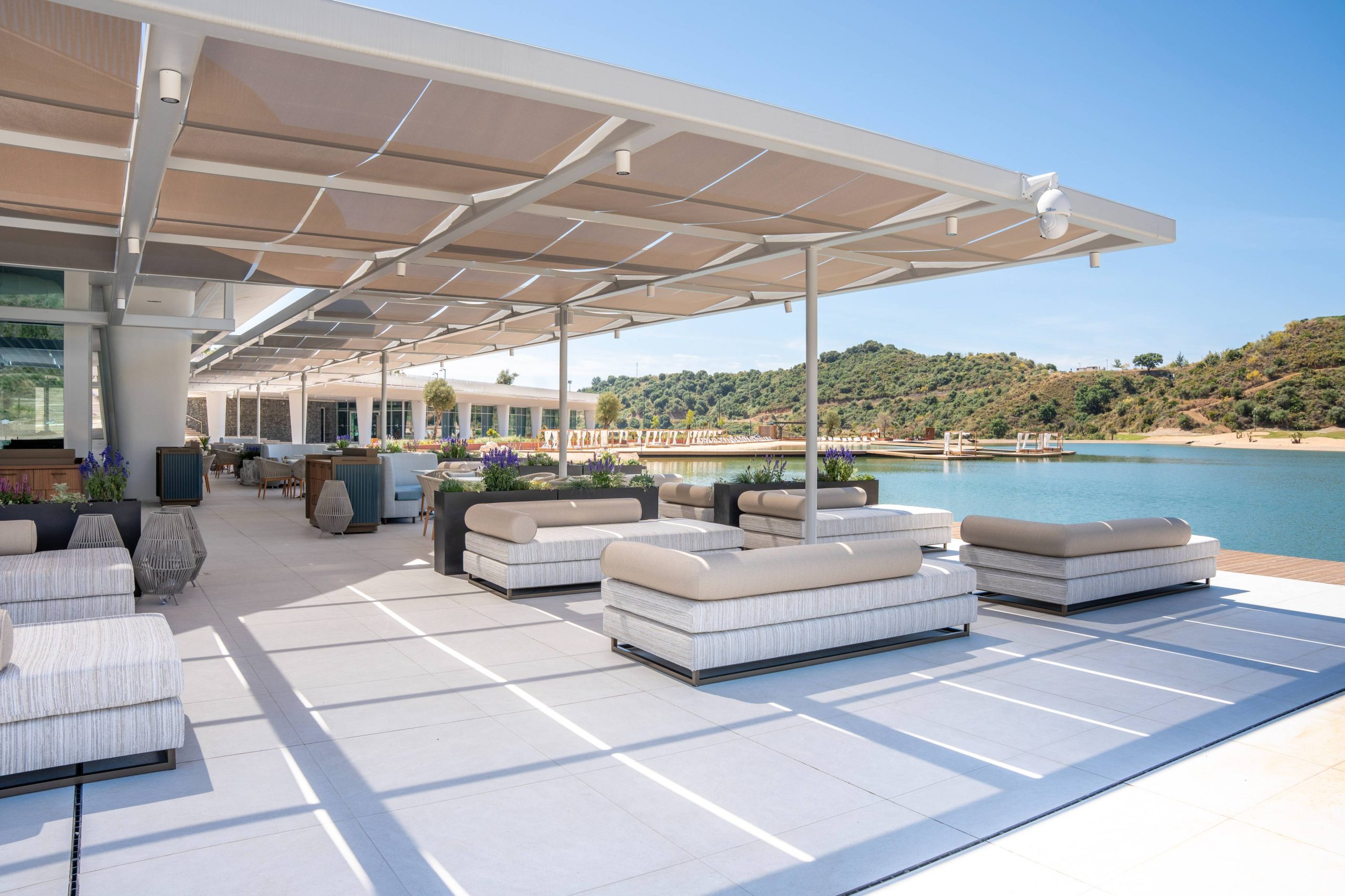 View of the shaded terrace of Saltao Marbella looking towards the lake and the hills beyond